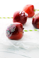 Sugar apple with red icing. Sweets paradise apple from market in Germany. Sweet candy Apple