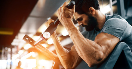 Strong ripped man training in gym