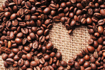 Heart shape made from coffee beans on a burlap