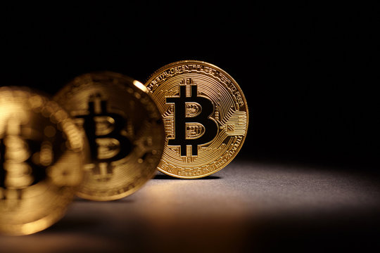 Golden Bitcoins Coins on black background