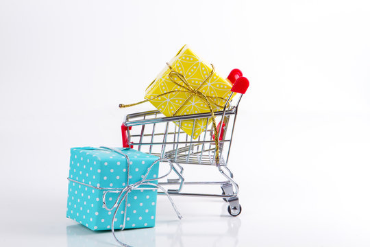 Trolley with gifts on a white background.