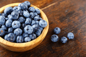 fresh blueberries in a wooden plate