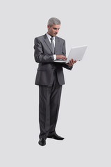 Naklejka na ściany i meble businessman standing with an open laptop