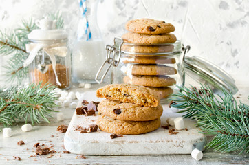 Chocolate chip cookies with milk on white background