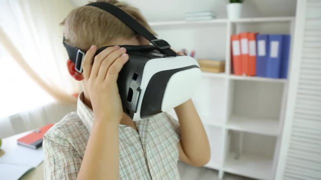 schoolboy explores virtual reality in vr-helmet
