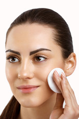 Beauty Face.Beautiful Woman With Natural Makeup.Skin Care.Woman Removing Face Makeup With Cotton Pad. CloseUp Girl With Nude Makeup Touching Perfect Soft Skin,Cleaning Fresh Face With Facial Tonic. 