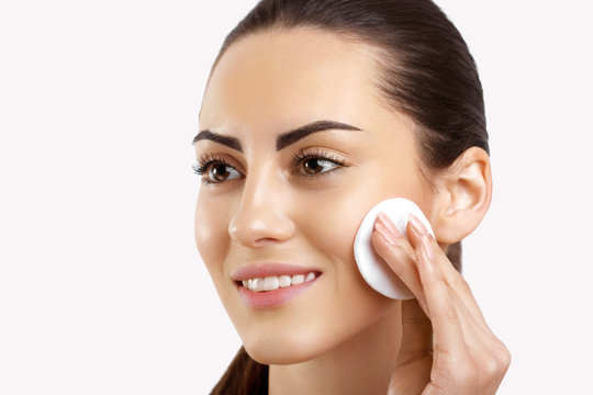 Beauty Face.Beautiful Woman With Natural Makeup.Skin Care.Woman Removing Face Makeup With Cotton Pad. CloseUp Girl With Nude Makeup Touching Perfect Soft Skin,Cleaning Fresh Face With Facial Tonic. 