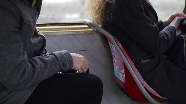 Pickpocket stealing phone from a woman's pocket in tram or bus