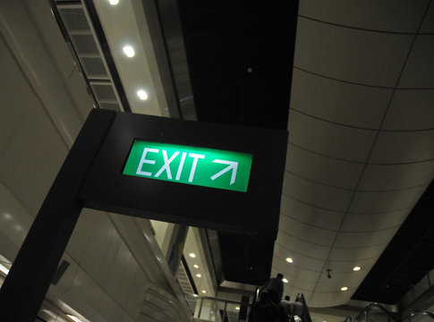 Green exit direction signage with up right arrow