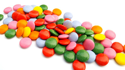 Colorful chocolate candies on white background