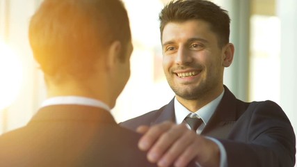 The businessmen pat on the shoulder. slow motion