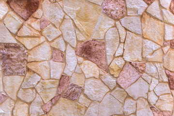Fototapeta na wymiar Background made of red stone wall
