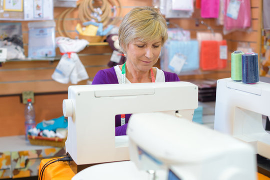 woman sewing on sewing-machine