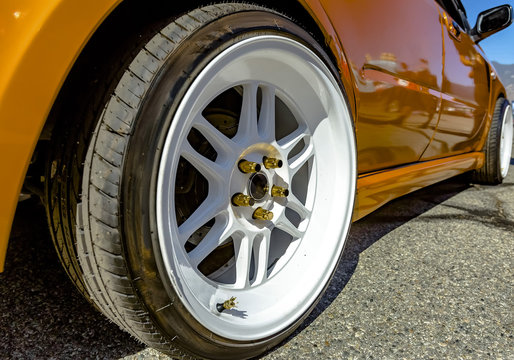 Flat White Rims On An Orange Car