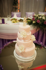 White wedding cake, pink color decorate with flower