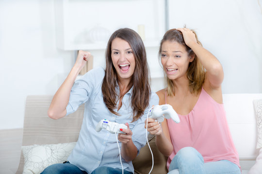 Young ladies playing computer game