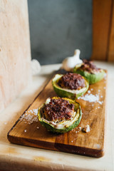 Stuffed round courgettes, with cow meat over a cutboard