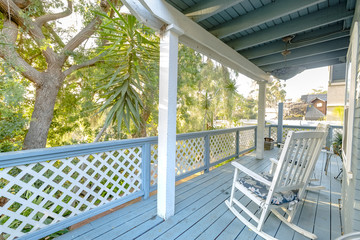 Take a rest with a white rocking chair on the deck