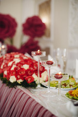 decorated wedding table glasses of red candle and flowers