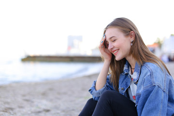 Portrait of cheerful girl who poses on camera and cute laughs si