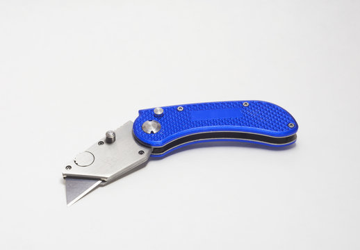 - Blue box cutter or utility knife with blade open