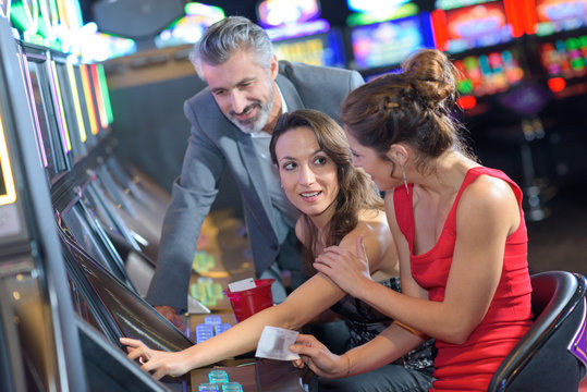 people playing slot machines in casino