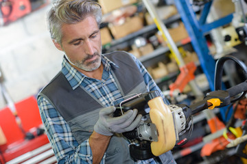 man fixing an outdoor equipment