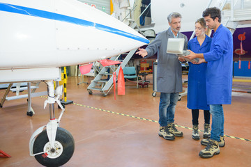 Obraz premium People having tour of aircraft hangar