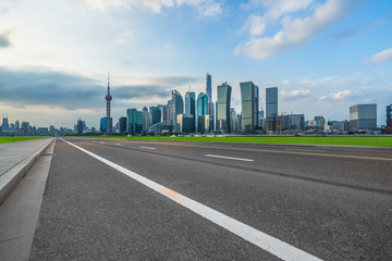 cityscape and skyline of shanghai from empty asphalt road.