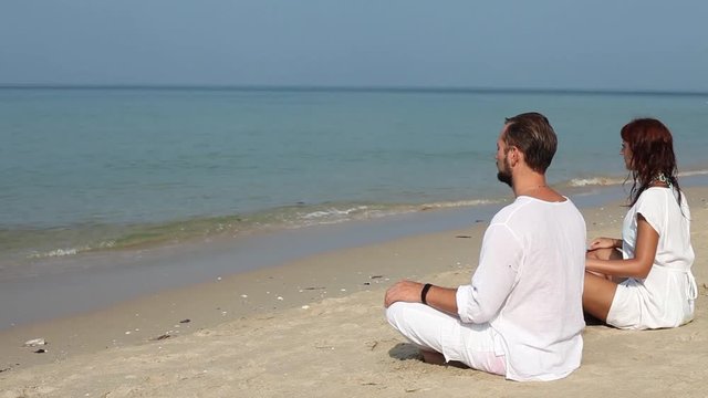 meditation, couple sitting on the beach, yoga concept