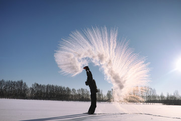 A man in the winter on the street. The guy walks on the winter r