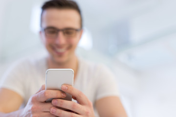 young man using a mobile phone  at home