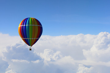 Aerostat floating in day sky. Mixed media