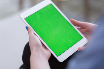 woman on sofa using tablet computer