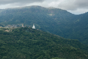 White big buddha aerial view with mountain background at Wat Prathat Phasornkaew, Khao Kho, Phetchabun, Thailand