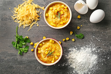 Ramekins with corn pudding and ingredients on table