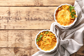 Ramekins with corn pudding on table