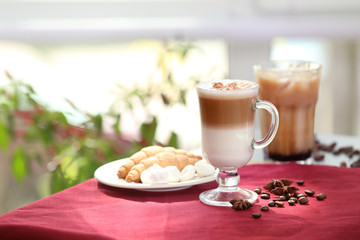 Glass with latte macchiato on table