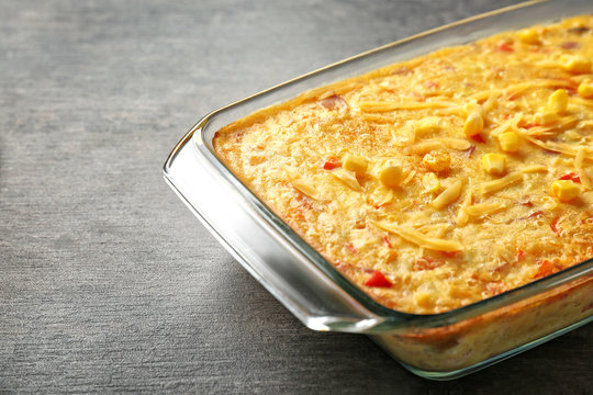 Baking dish with corn pudding on table