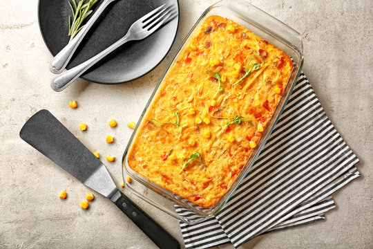 Baking dish with corn pudding on table