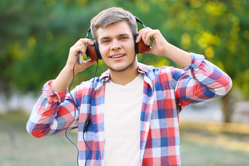 Teenager boy with headphones listening to music outdoors