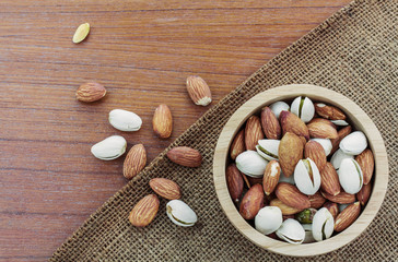 Almonds in bowls on sacks.