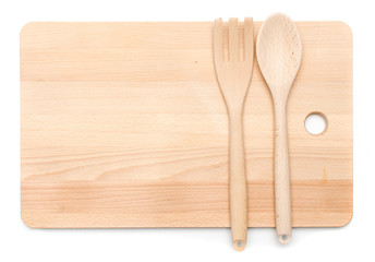 kitchenware utensil wooden spoon and fork laying on chopping wood