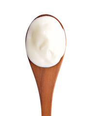 yogurt on wooden spoon isolated on white.