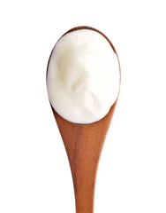 Fototapeten yogurt on wooden spoon isolated on white. © nipaporn