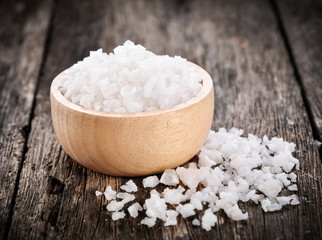 salt in bowl on wooden background