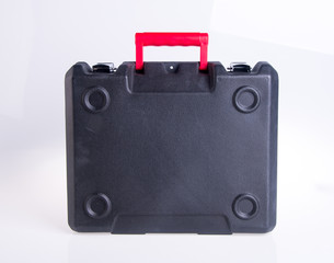 Black plastic tool box on the background