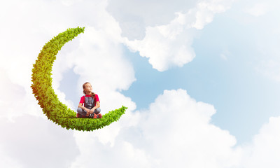 Concept of careless happy childhood with girl dreaming about something