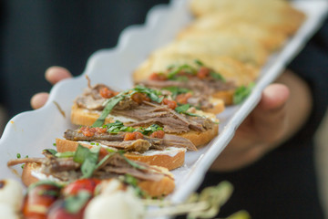 Appetizer on a long white platter.