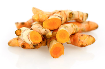 Turmeric roots on white background.